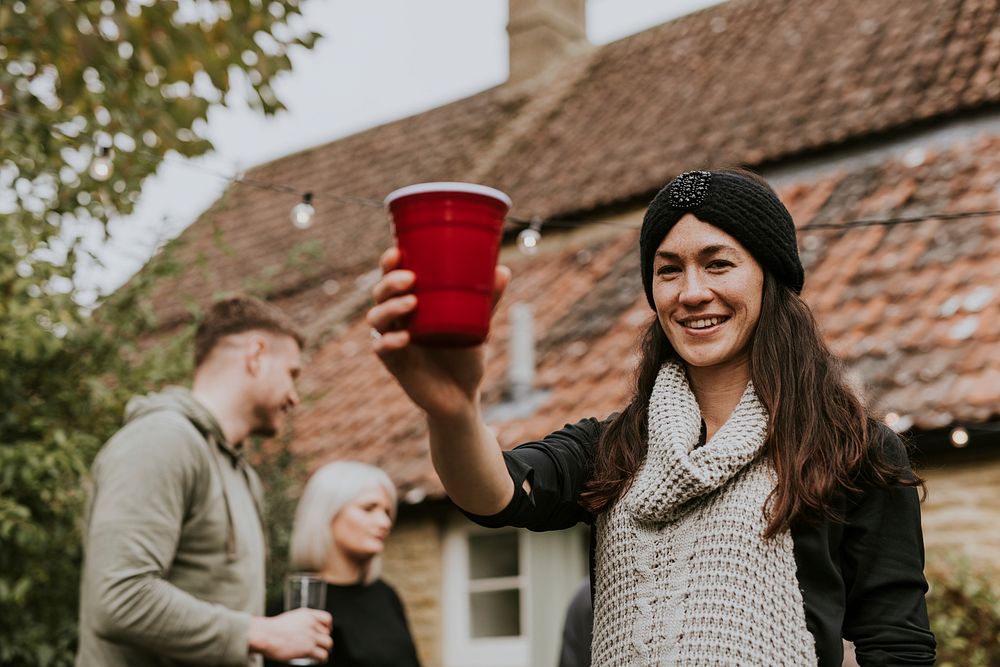 Happy friends toasting to celebrate at a Christmas party