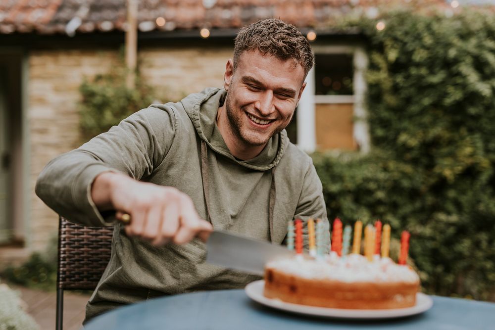 Man slicing a piece of cake at a birthday party