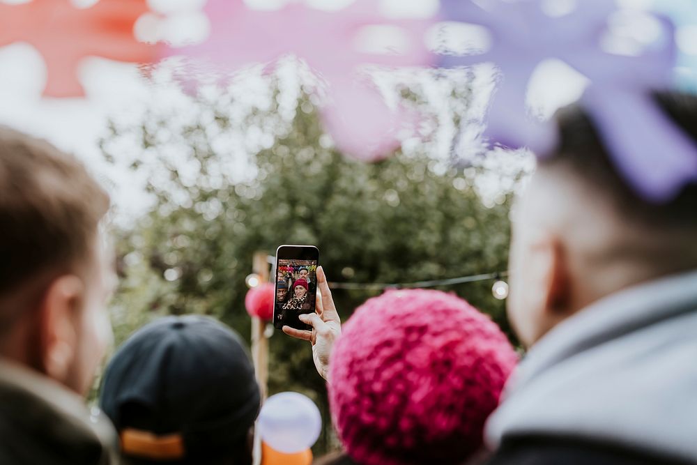 Diverse friends taking a group selfie at a Christmas party 