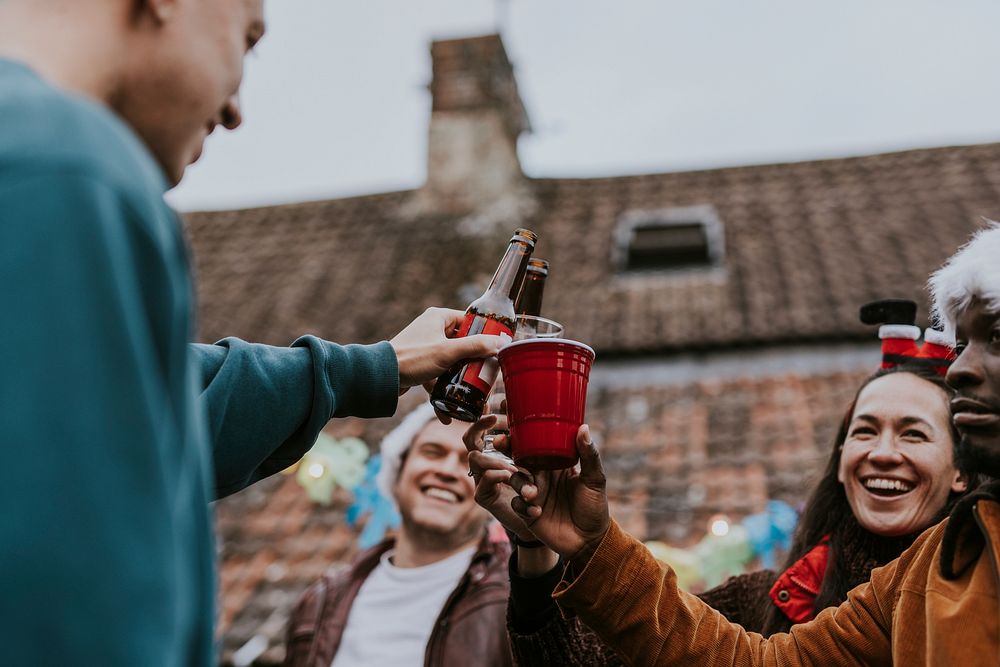 Happy friends toasting to celebrate at a Christmas party