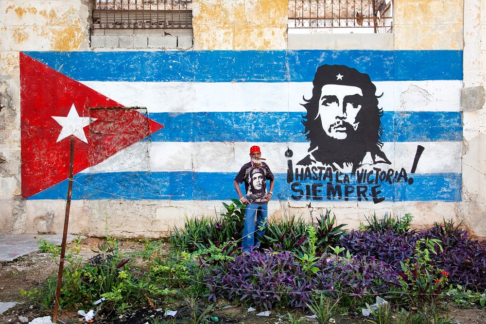 Neighborhood in Old Havana with hand painted mural showing the Cuban flag and Che Guevara. Original image from Carol M.…