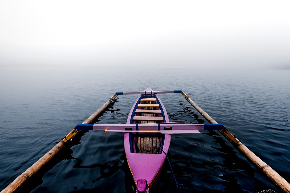 Pink canoe in the mist on a lake in Bali