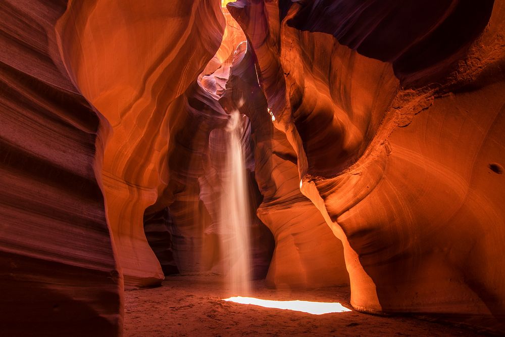 Golden glowing red walls, twisted rock faces and beams of light shining through the Antelope Canyon, United States
