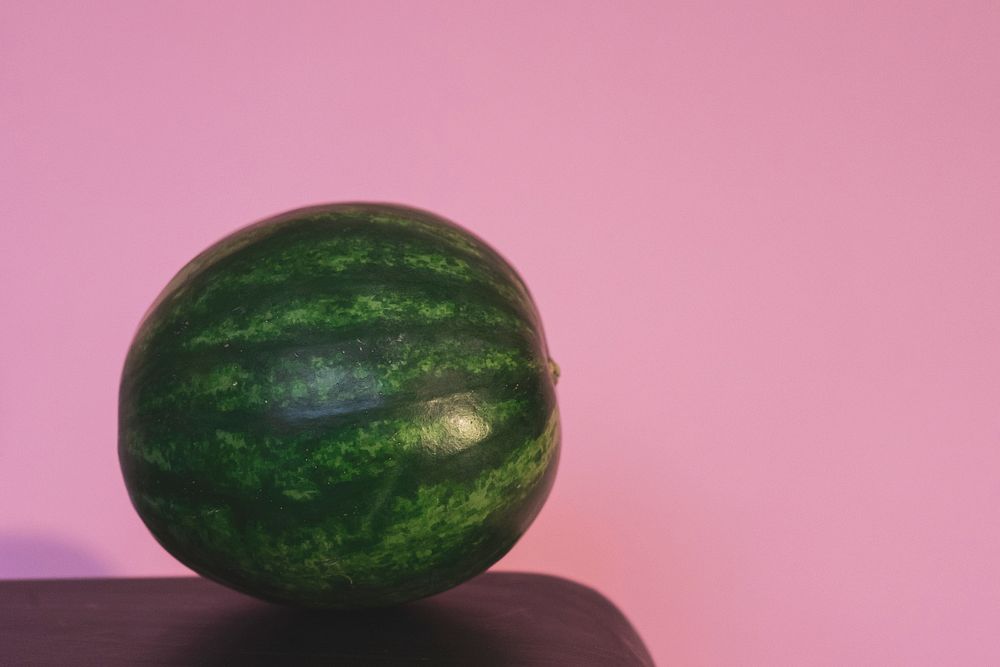 Whole watermelon on pink background