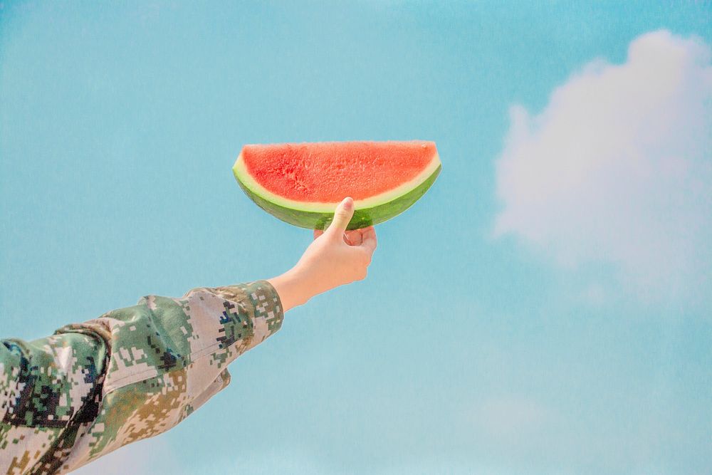 Woman holding up a watermelon