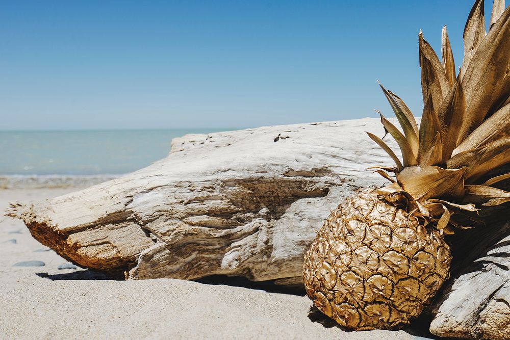 Golden pineapple on a beach