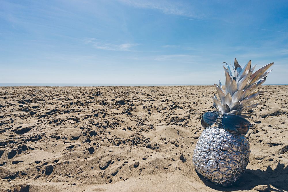 Silver pineapple on a beach