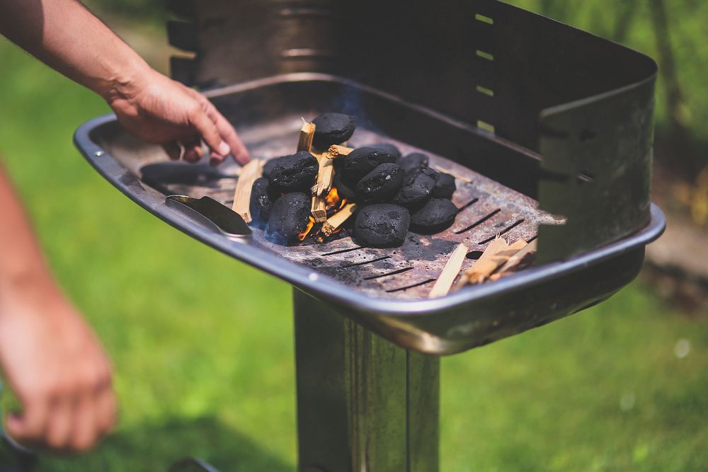 Burning charcoals in a barbecue grill. Visit Kaboompics for more free images.