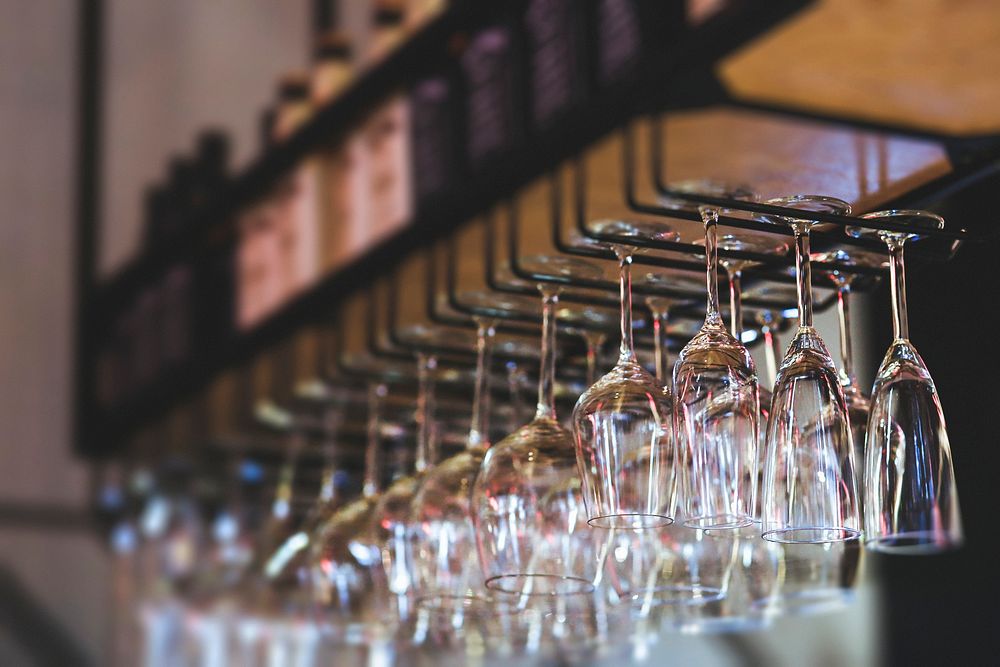 Wine glasses hanging in a bar. Visit Kaboompics for more free images.