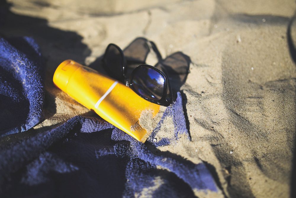 Sunglasses in the sand on a beach. Visit Kaboompics for more free images.