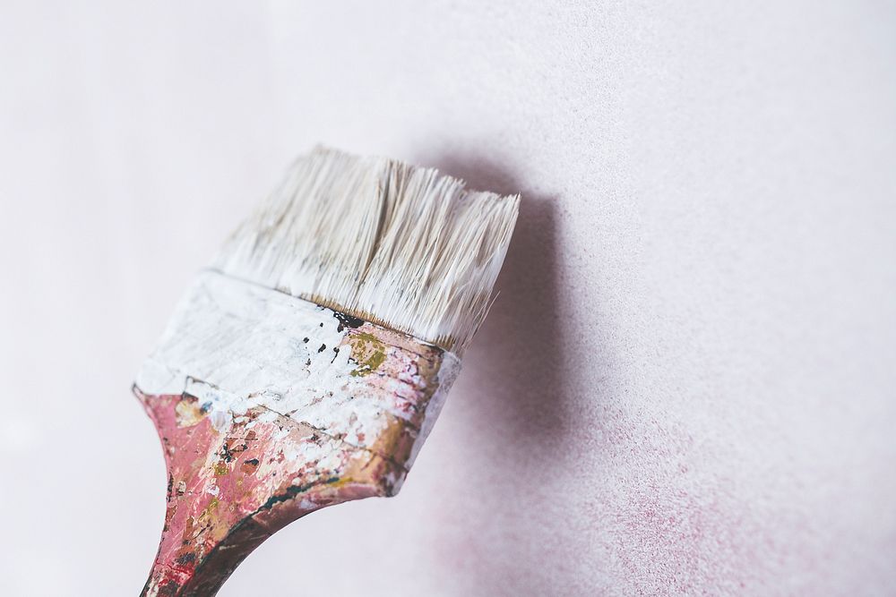 Paintbrush with white paint. Visit Kaboompics for more free images.