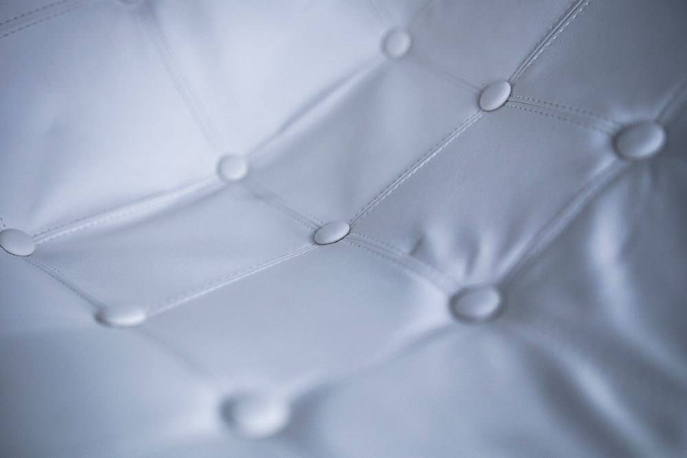 Close up of a white sofa. Visit Kaboompics for more free images.