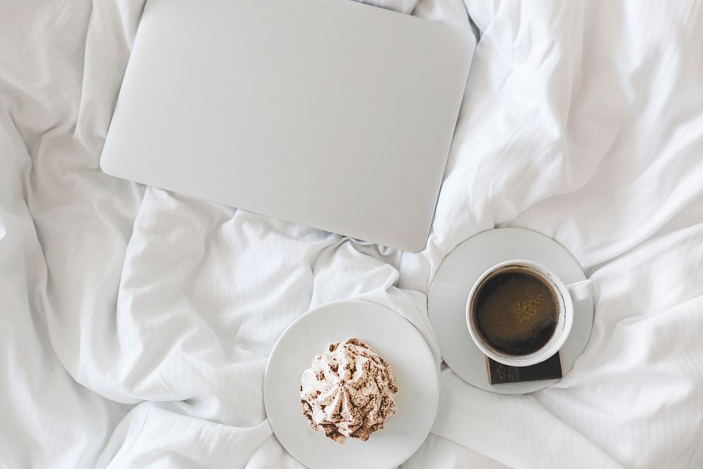 Laptop and a coffee in bed. Visit Kaboompics for more free images.