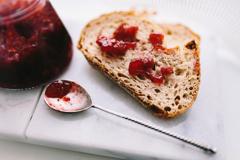 Strawberry jam on bread. Visit Kaboompics for more free images.