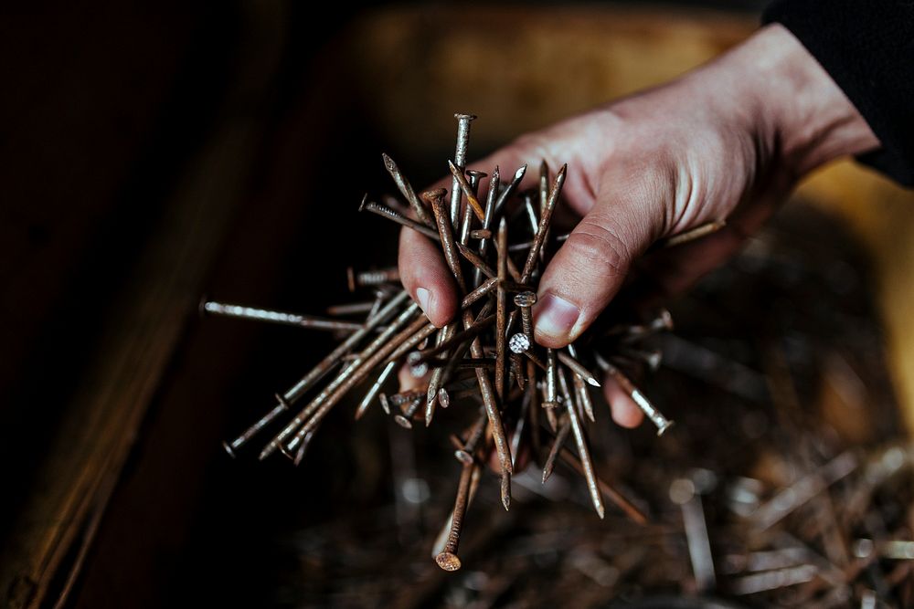 Man holding some rusty needles. Visit Kaboompics for more free images.