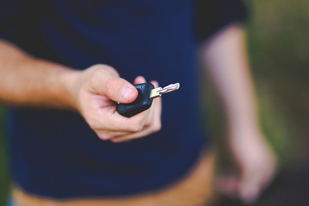 Man holding a car key. Visit Kaboompics for more free images.