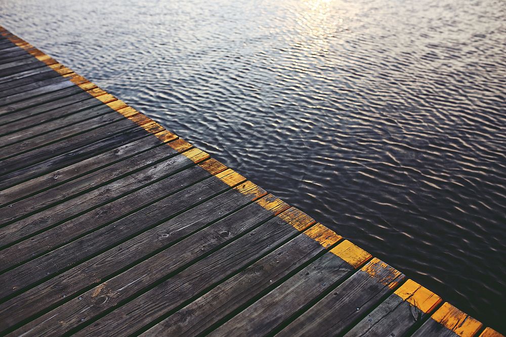 Wooden jetty by the water. Visit Kaboompics for more free images.