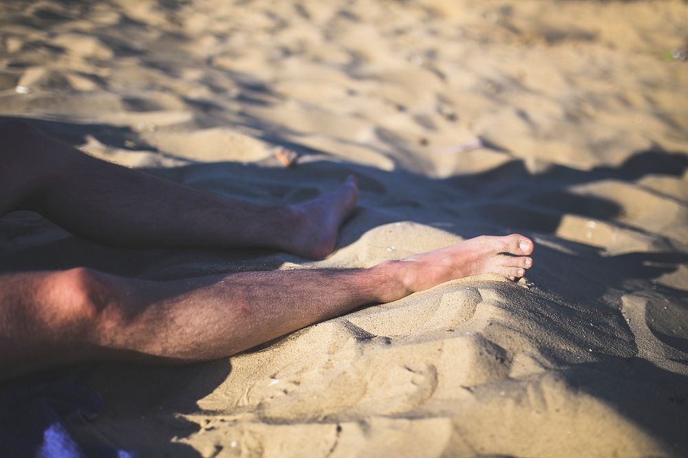 Man sitting in the sand. Visit Kaboompics for more free images.