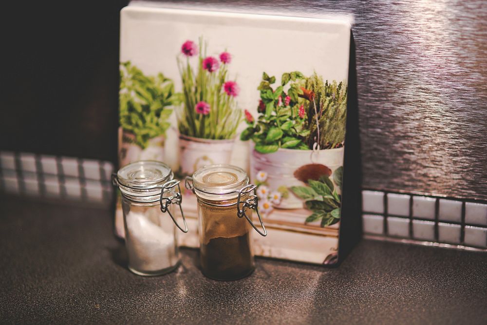 Frame and spices on a countertop. Visit Kaboompics for more free images.