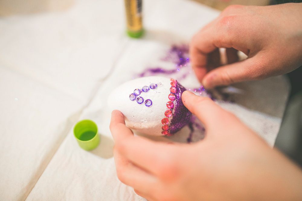 Woman decorating an egg. Visit Kaboompics for more free images.
