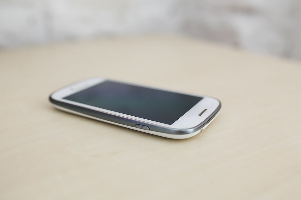 Smartphone on a table. Visit Kaboompics for more free images.