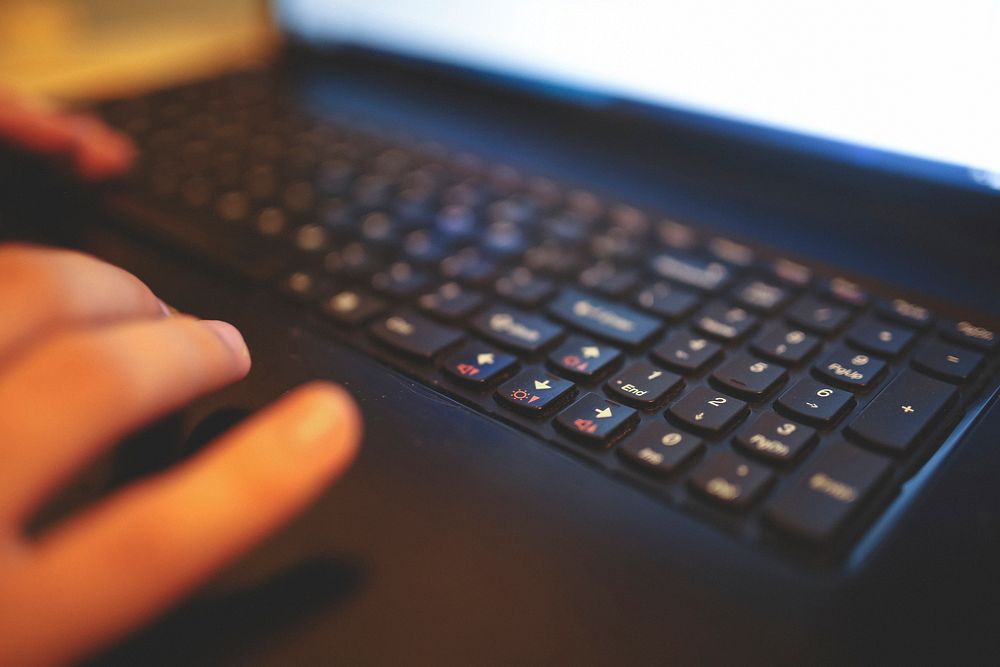 Man typing on a keyboard. Visit Kaboompics for more free images.