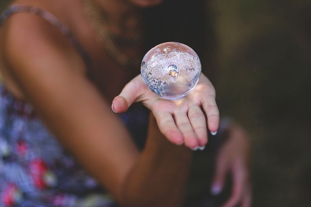 Woman holding a crystal ball. Visit Kaboompics for more free images.