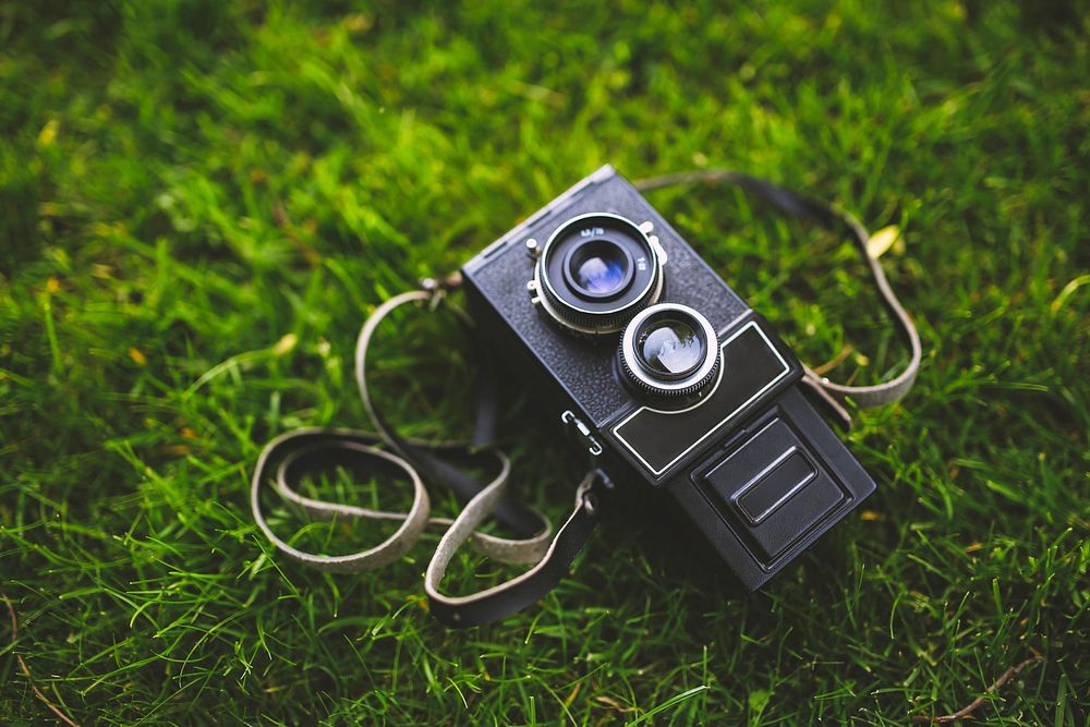 Vintage analog film camera on a grass. Visit Kaboompics for more free images.