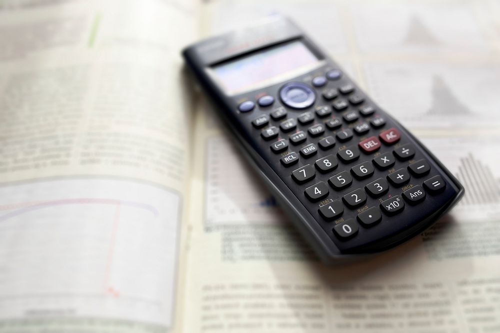 Black calculator on a mathematics book. Visit Kaboompics for more free images.