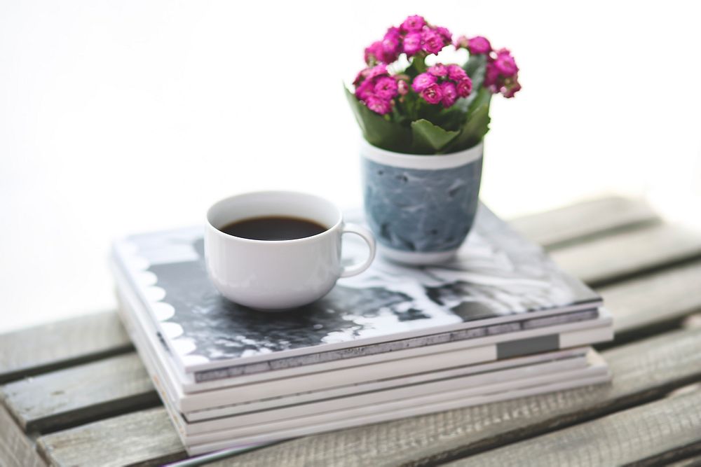 Cup of coffee and flowers on a table. Visit Kaboompics for more free images.