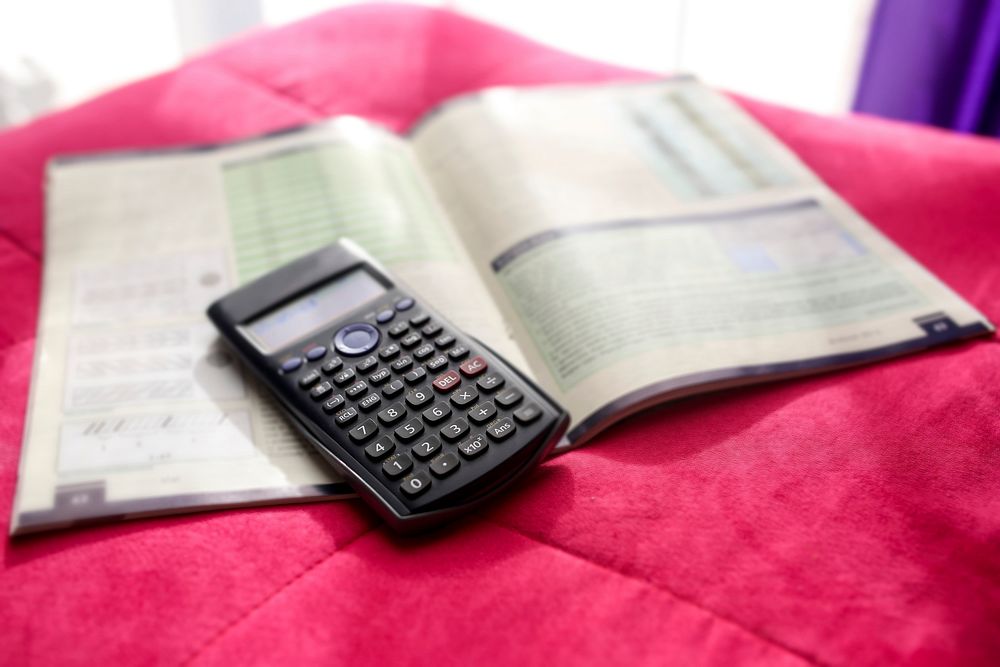 Calculator and a mathematics book. Visit Kaboompics for more free images.