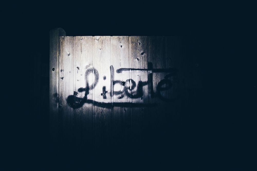 Liberte graffiti on a wooden texture