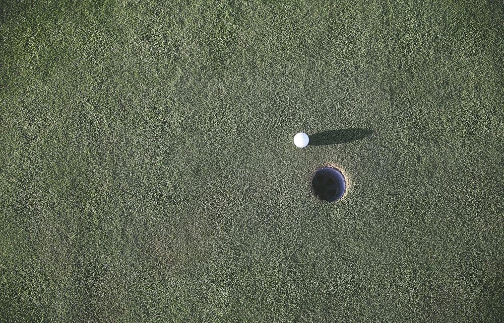 Golf ball near the hole on a putting green