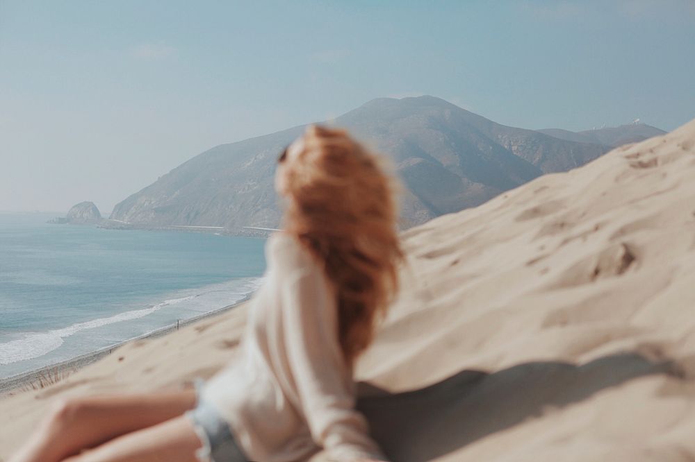 Blonde woman on a sand dune
