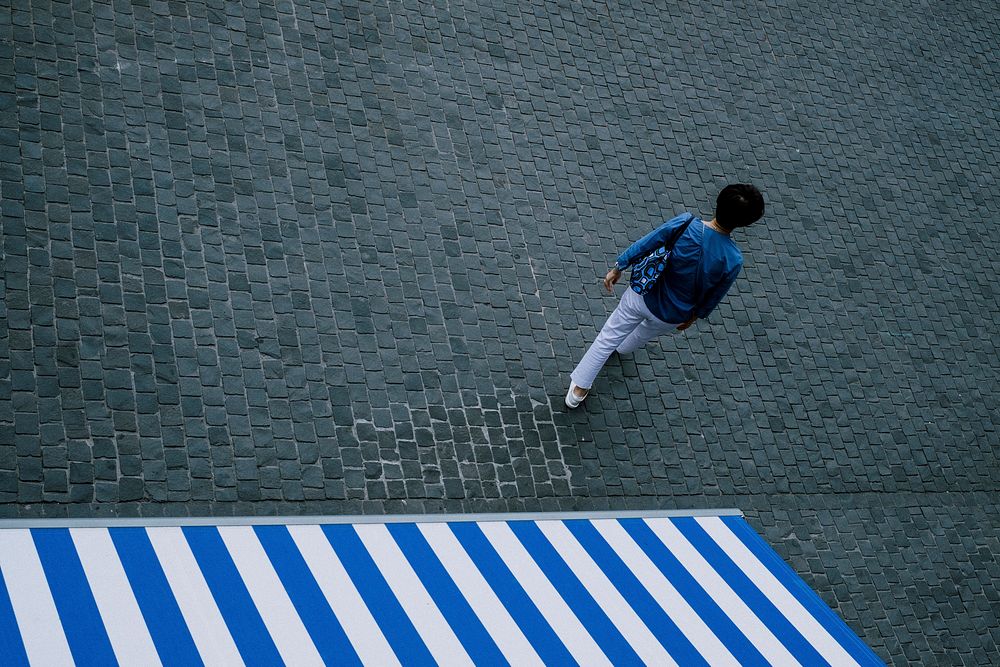Aerial view of a man walking down a square