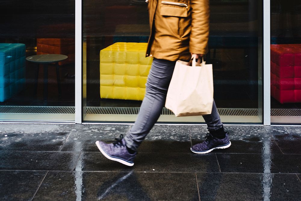 Man walking down a wet street