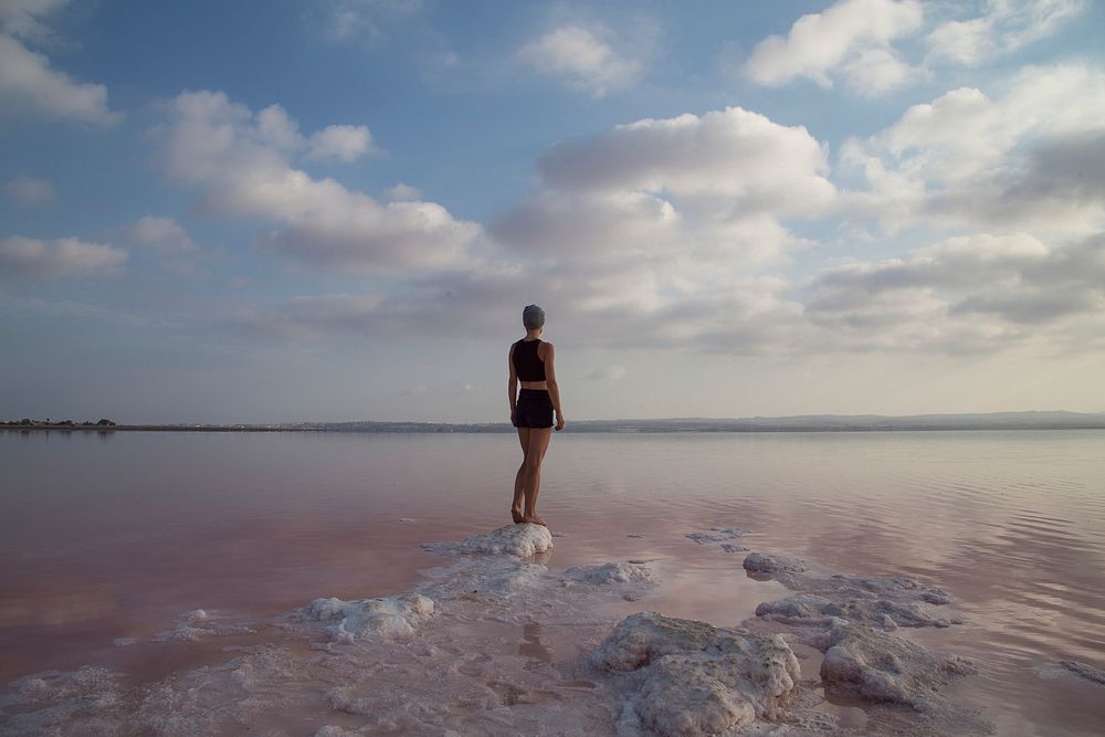 Woman in bathing suit looking across the salty beach