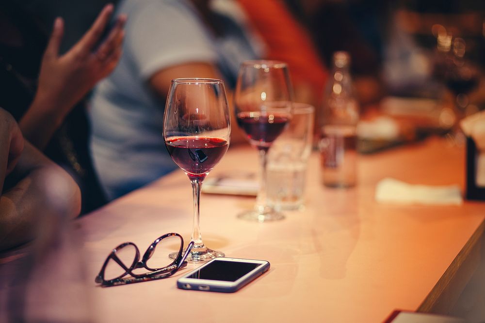 People drinking wine at a bar