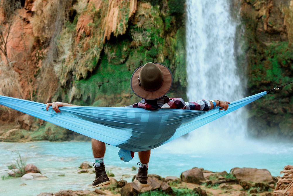 Man chilling by a waterfall