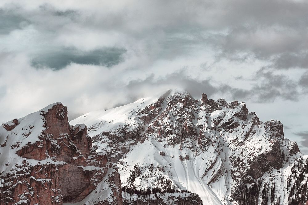 The snow atop the foggy summit of the Dolomites