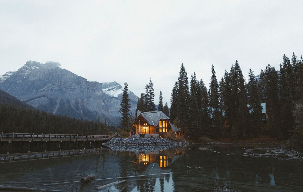 House by the emerald lake in the forest