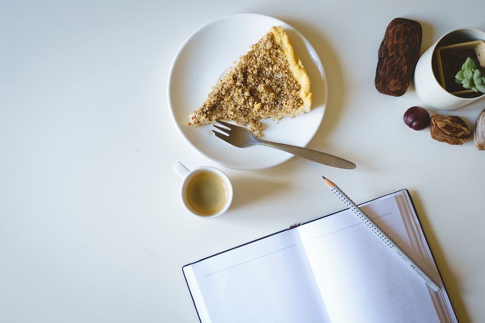 Writing a journal while having coffee and cake