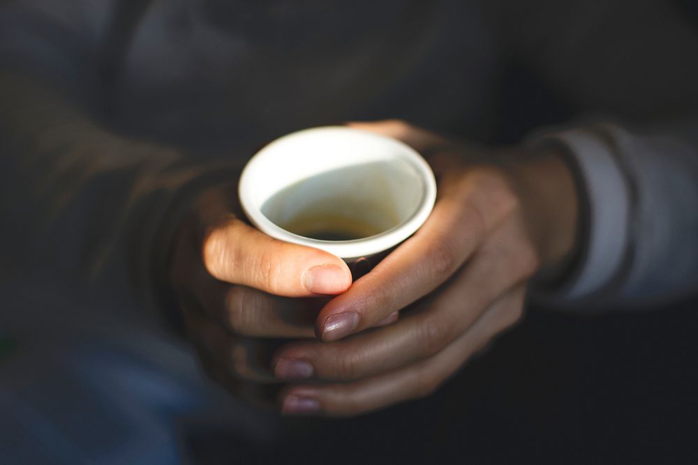 Woman holding a cup of espresson