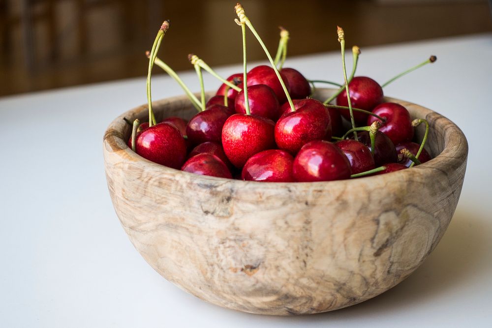 Fresh cherries in a wooden bowls