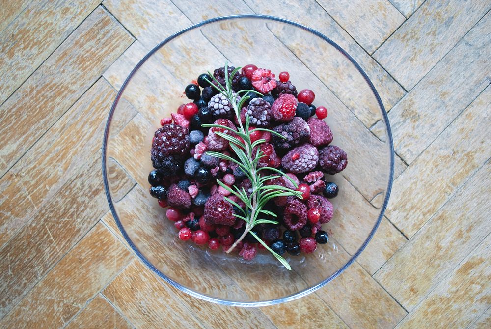 Mix berries in a glass bowl