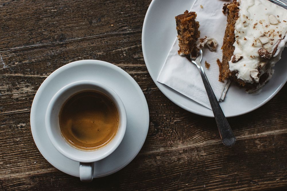 Aerial view of a coffee cup and a piece of cake food photography