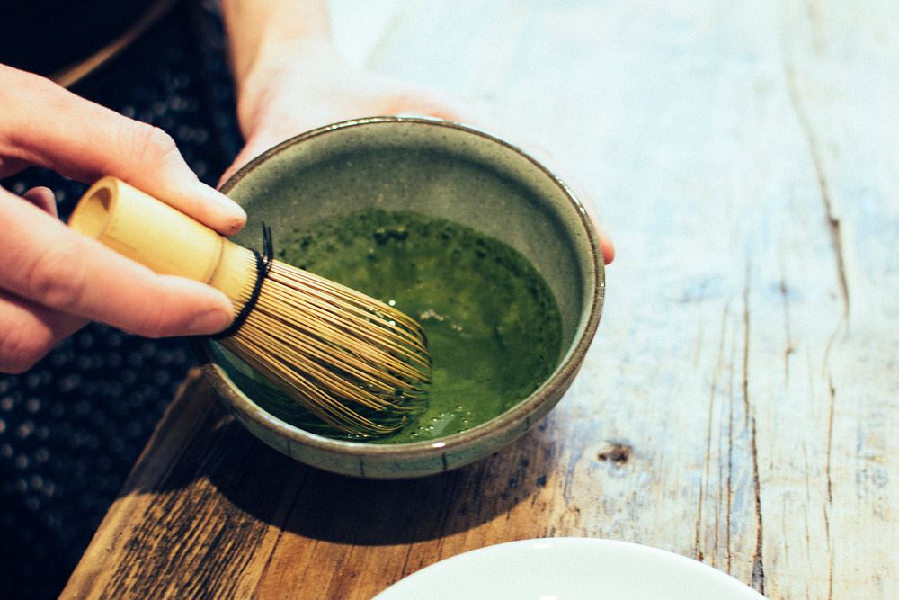 Hand whisking a Matcha tea