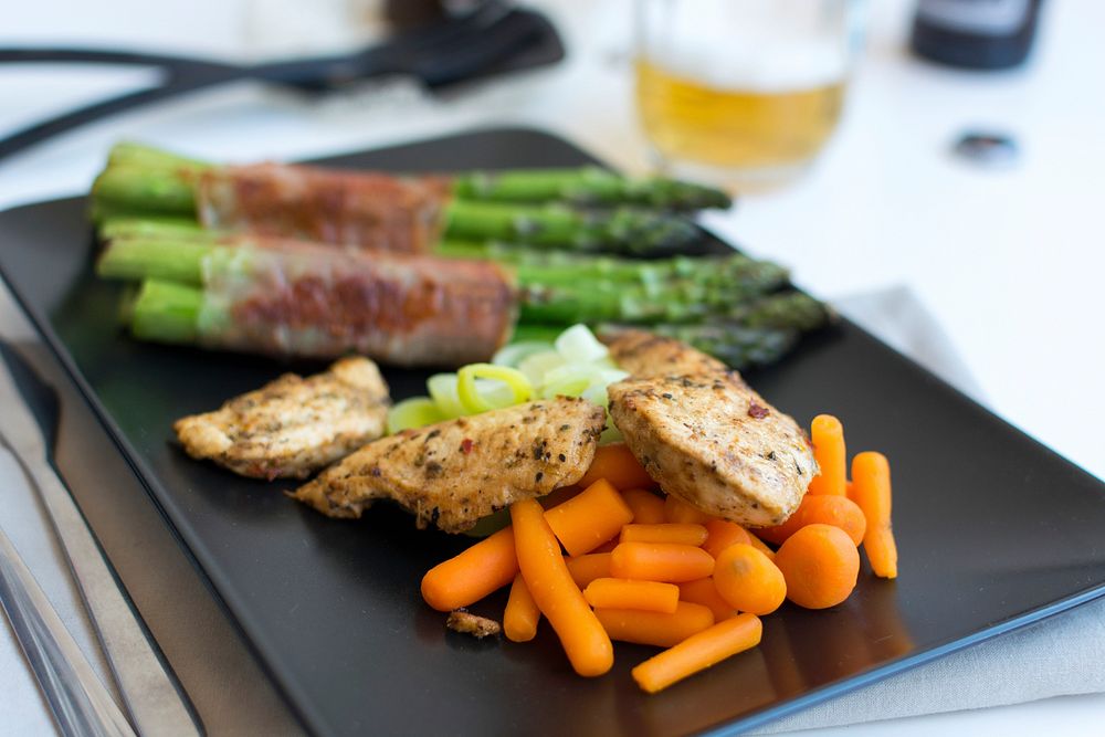 Chicken breast steak with vegetables and a glass of beer