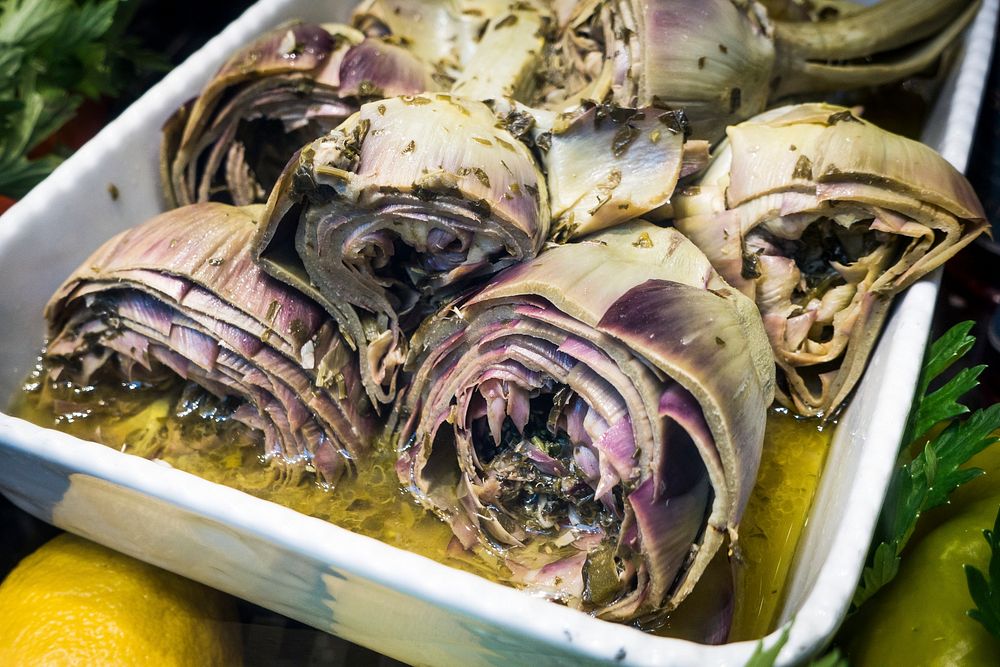 Cooked artichokes in a stainless container