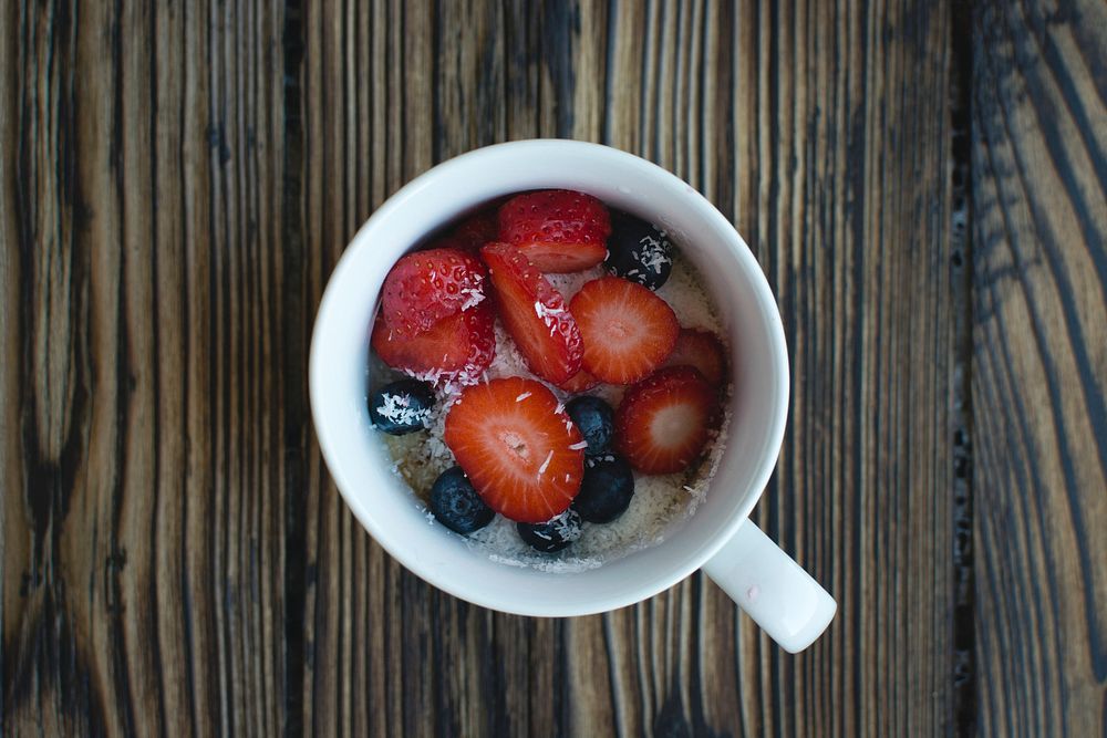 Oatmeal with berries and coconut in a cup